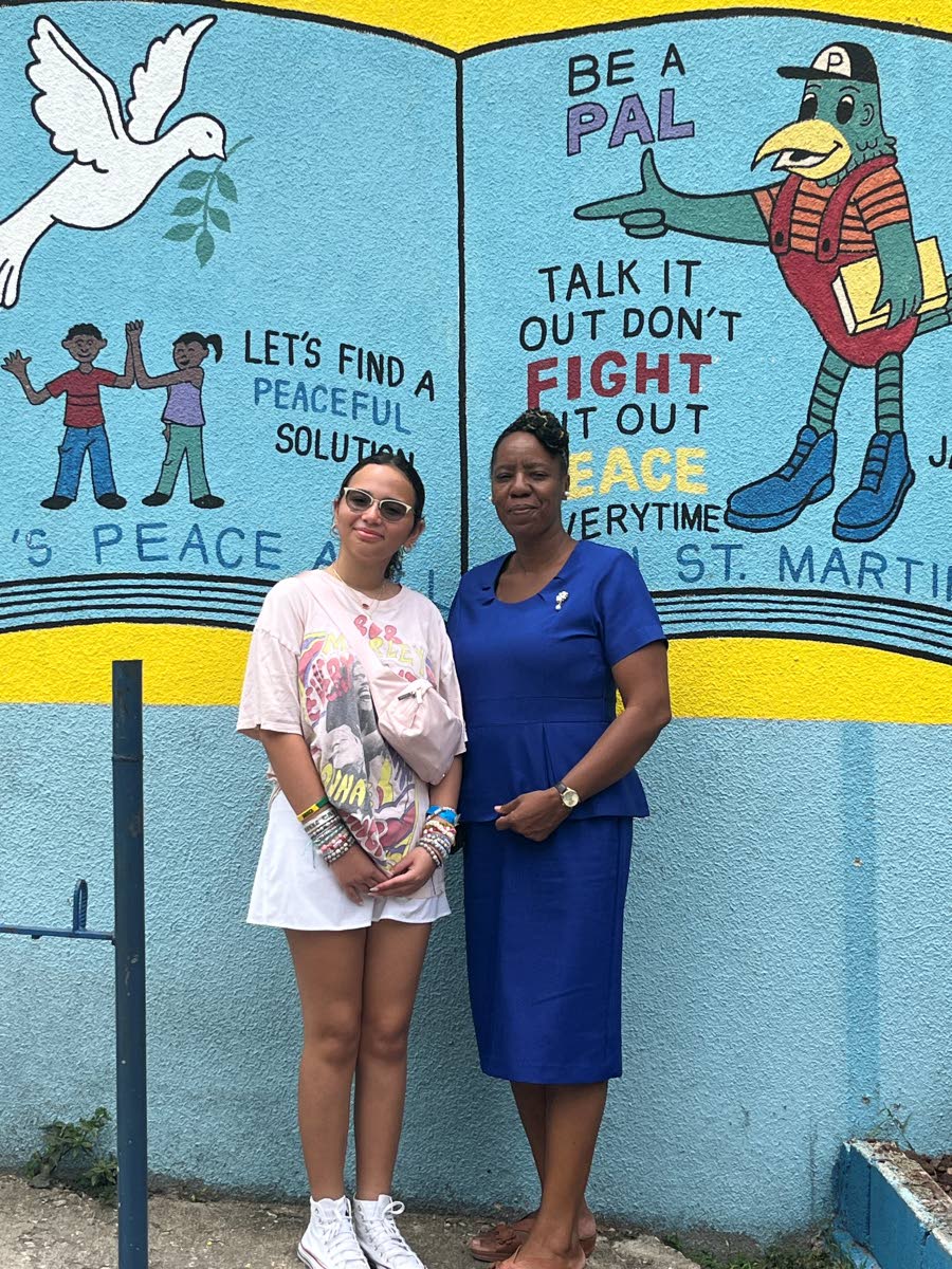 Sixteen-year-old Bridget Robbins (left) with Lorraine Campbell Hartley, acting principal of St Martin de Porres Primary, at the school in Gordon Town, St Andrew.