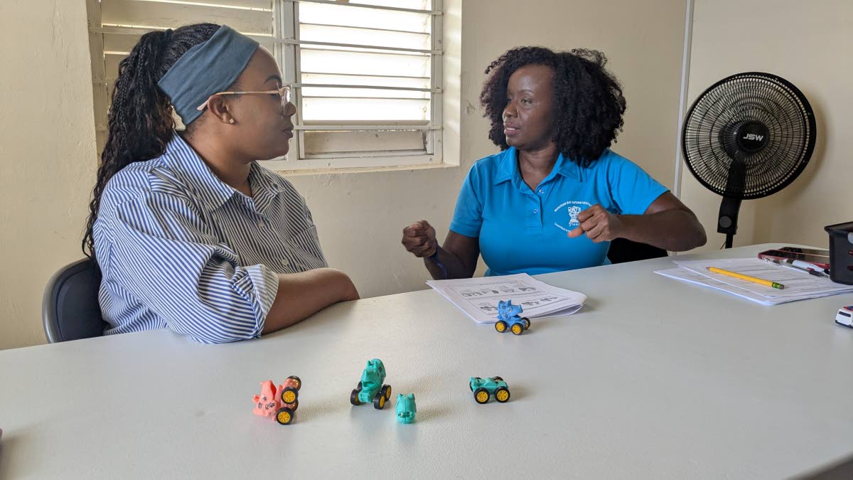 Parent Corrette Foster-Ladrey (left) listens to tips to engage her five-year-old son from Adama Blagrove, founder and owner of the Montego Bay Autism Centre. Blagrove is one of 10 master trainers being trained at the Caregiver Skills Training programme org