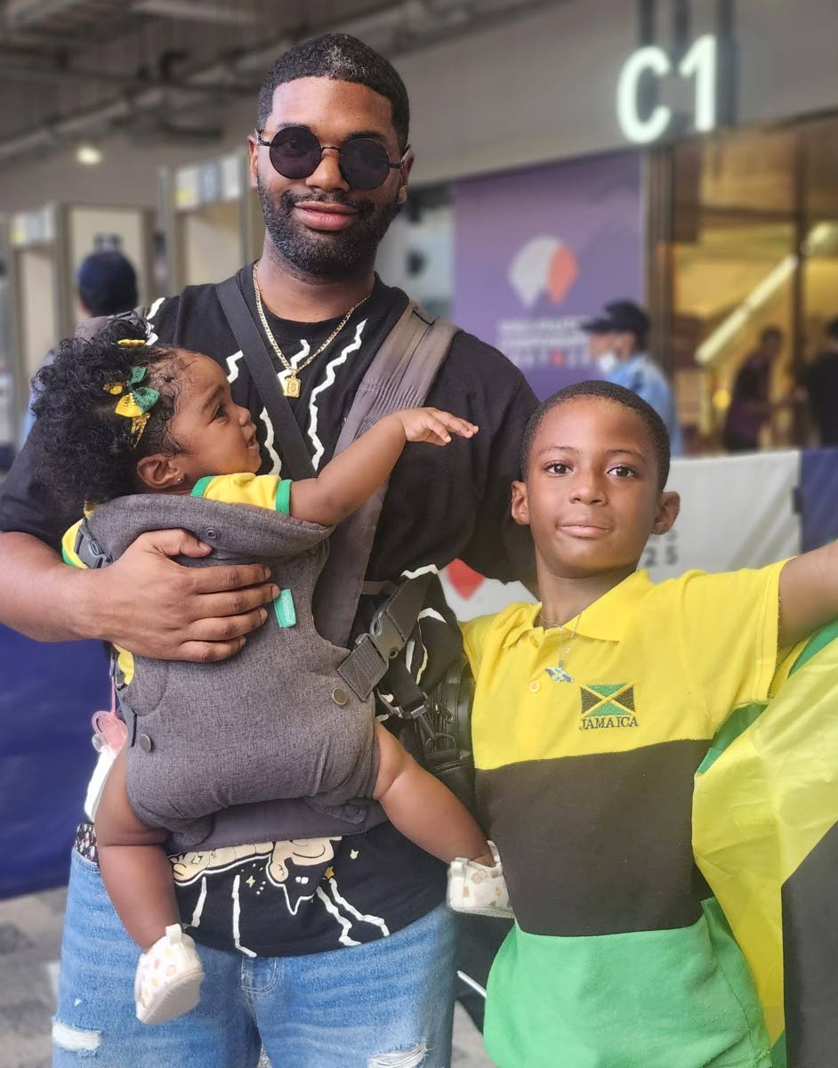 Chanise Henry’s husband, Shaka Henry, son Machel Shepherd and daughter, Zariya Avery at the Japan National Stadium on Snday.