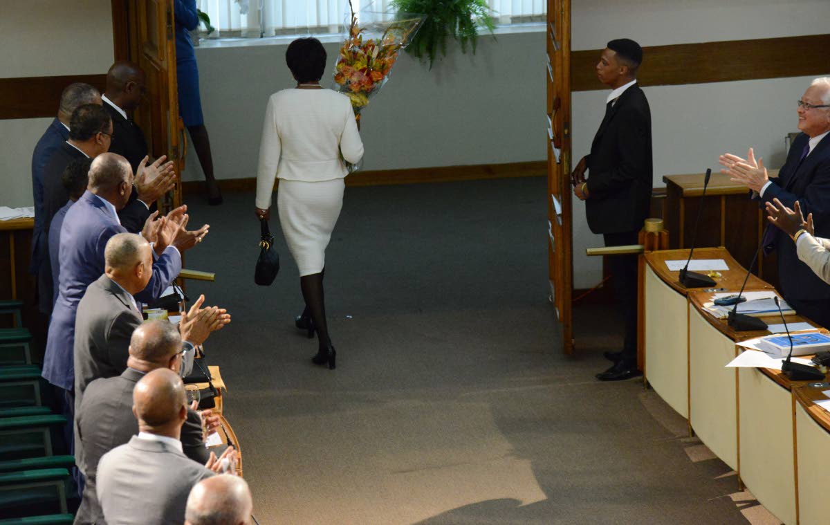 Former Prime Minister Portia Simpson Miller walks out of Gordon House for the final time on June 16, 2017 to a salute from both sides of the House.