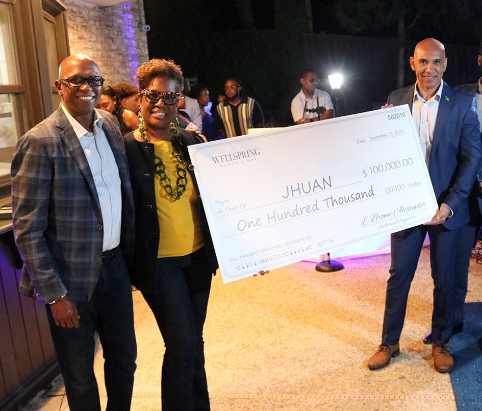 Jamaica’s ambassador to the United States, Major General (Ret’d) Antony Anderson (right), receives a cheque for US$100,000 from Lisa Brown Alexander (second left), a Howard alum and owner of Wellspring Manor & Spa in Upper Marlboro, Maryland, on behalf