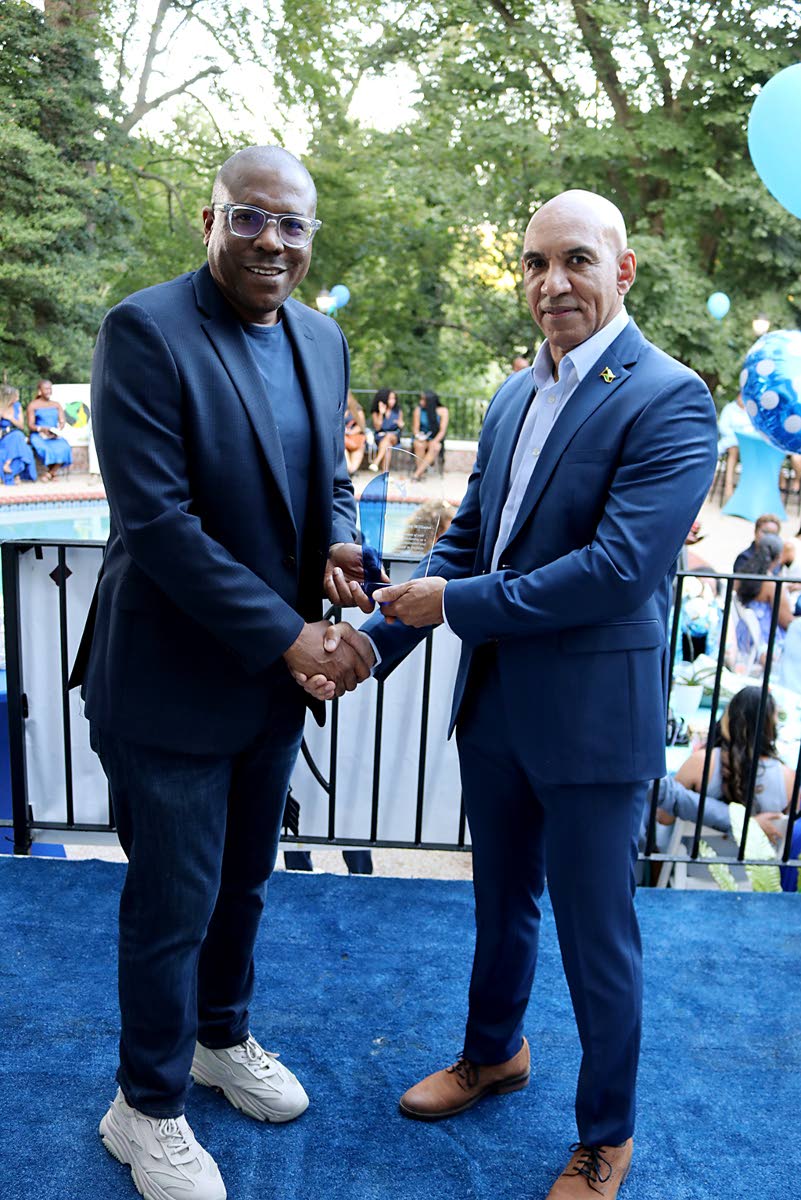 Jamaica’s ambassador to the United States, Major General (Ret’d) Antony Anderson (right), presents 2025 JHUAN’s IMPACT award to Christopher Williams, former CEO of NCB Capital Markets, who was recognised for his role in transforming the Caribbean fin