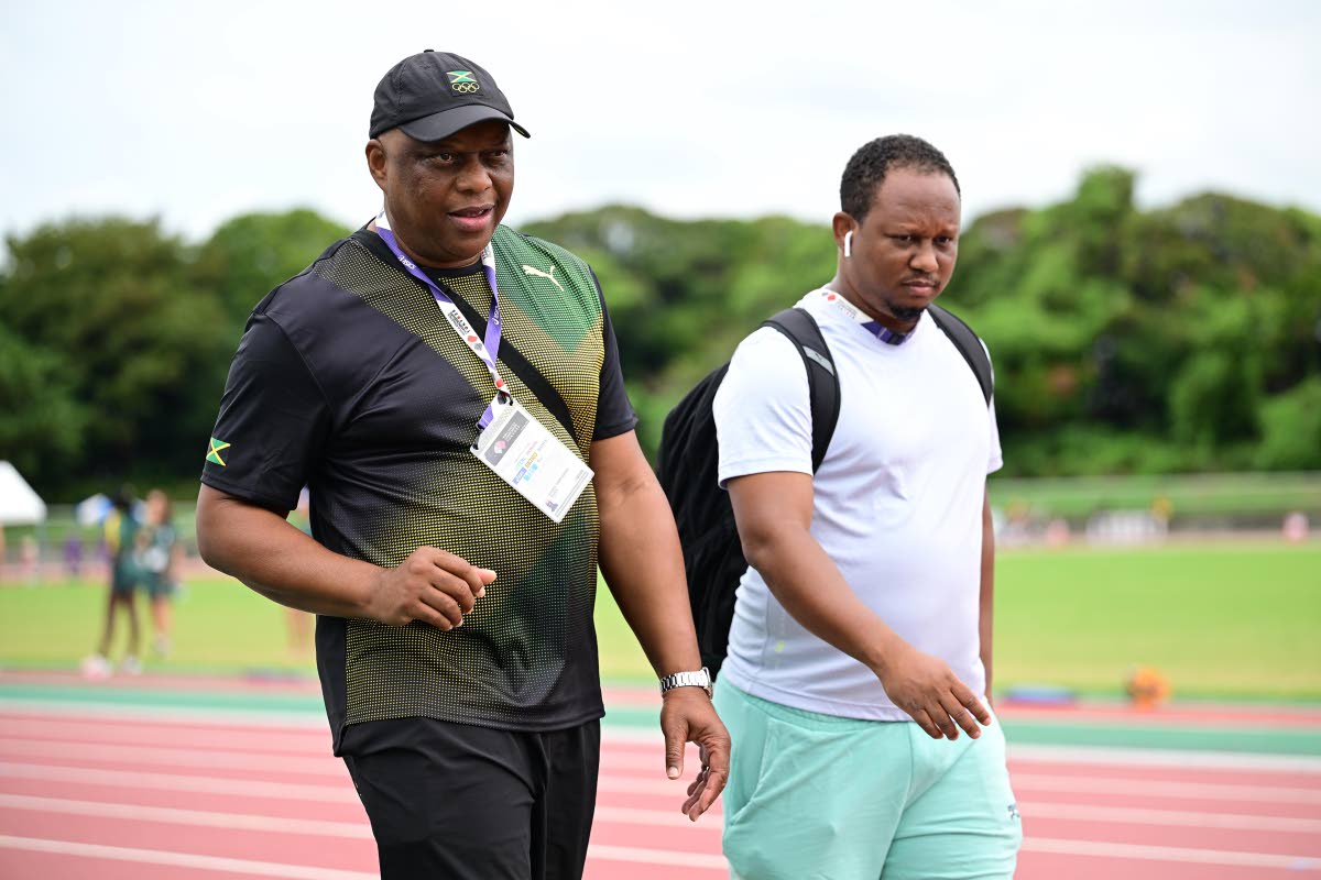 Jamaica’s technical director, Maurice Wilson (left) speaks with coach, Michael Frater, after a training session at the Athletic Stadium at the Oi Central Seaside Park Sports Forest, Shinagawa,Tokyo, Japan.