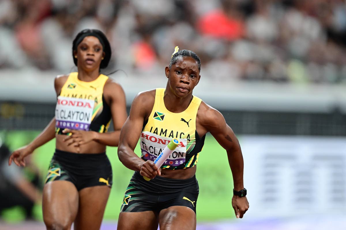 Tina Clayton takes off after a baton exchange with sister Tia (left) during the women’s 4x400-metre relay heat they won to advance to the World Athletics Championships final yesterday.