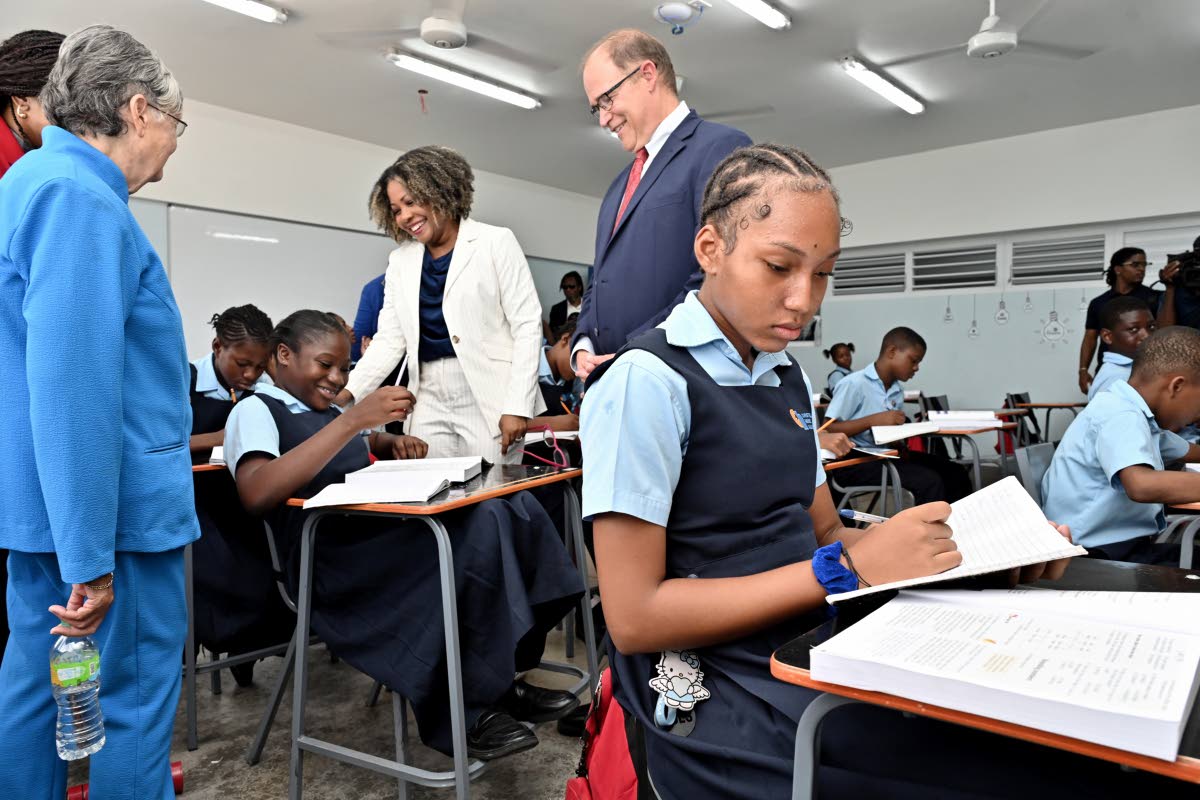 Senator Dr Dana Morris Dixon (centre), minister of education, skills, youth and information; Sally Porteous (left), and David Harris (centre), president and CEO of Christel House International; speaking with the student Icana Blackwood (second left) during
