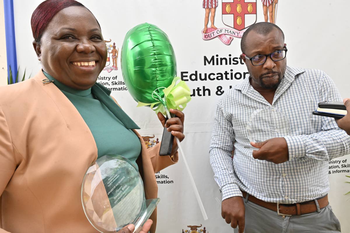 Acting principal Beverley Feare and Haniff Nembhard, mathematics teacher at Maud McLeod High School, with their awards at the Tactical Approach Awards 2025 for excellence, in recognition of being among the top 20 teachers from high schools with the highest