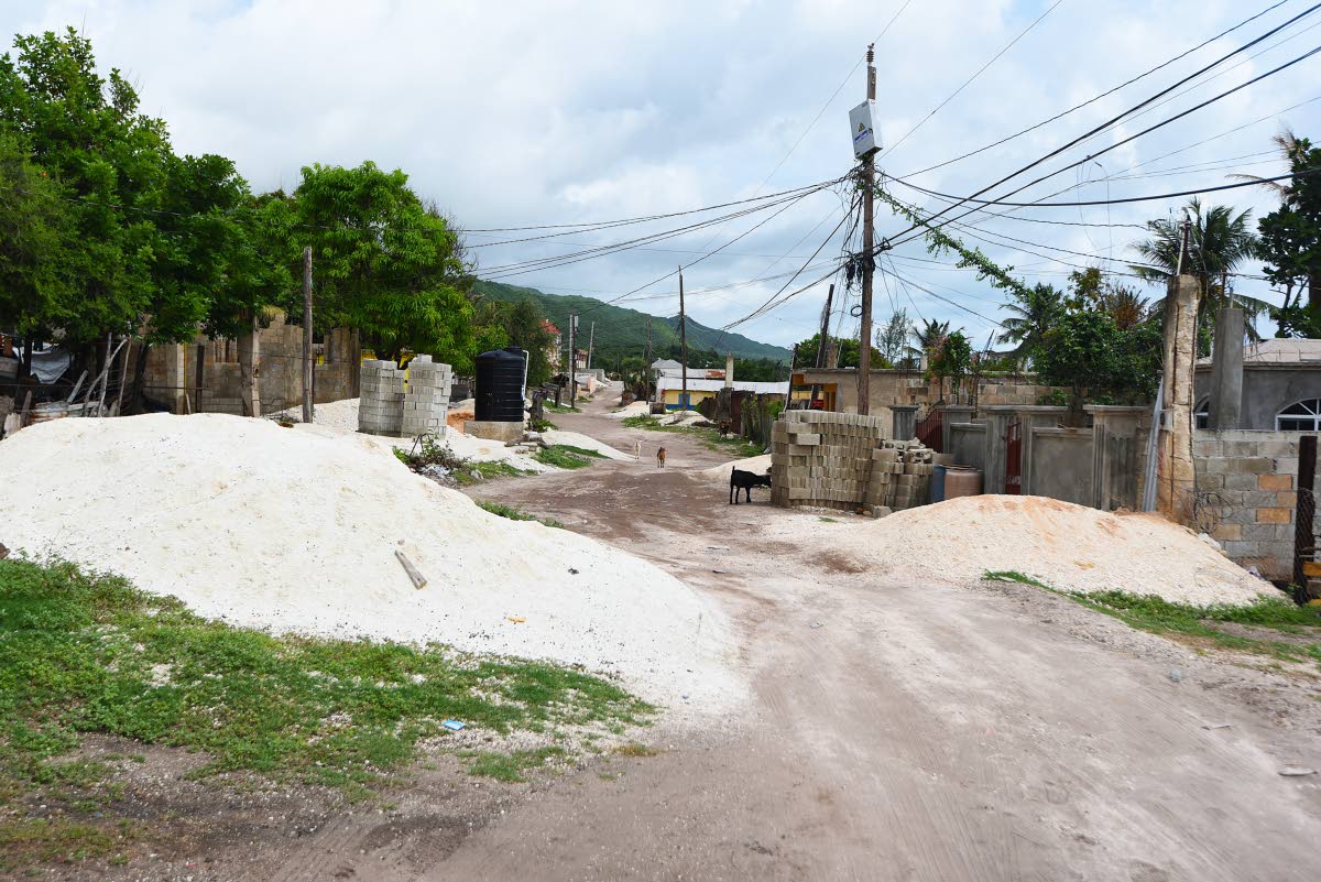 A lane filled with construction material in the Compound section of Alligator Pond, Manchester, last Friday.