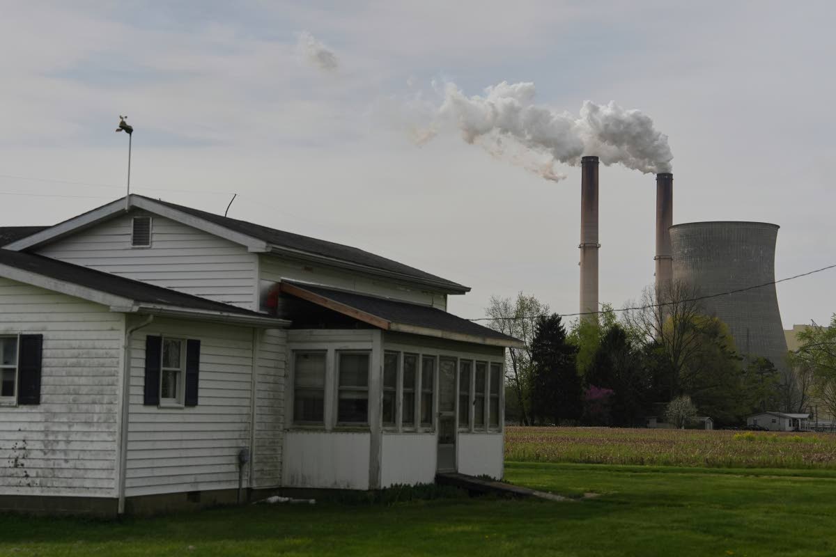 A home sits near a coal-fired power plant, April 14, 2025, in Cheshire, Ohio.