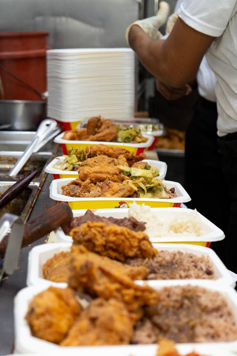 Fried chicken is served with rice and peas at Chicken & Tings to assist in the relief effort for Hurricane Melissa.