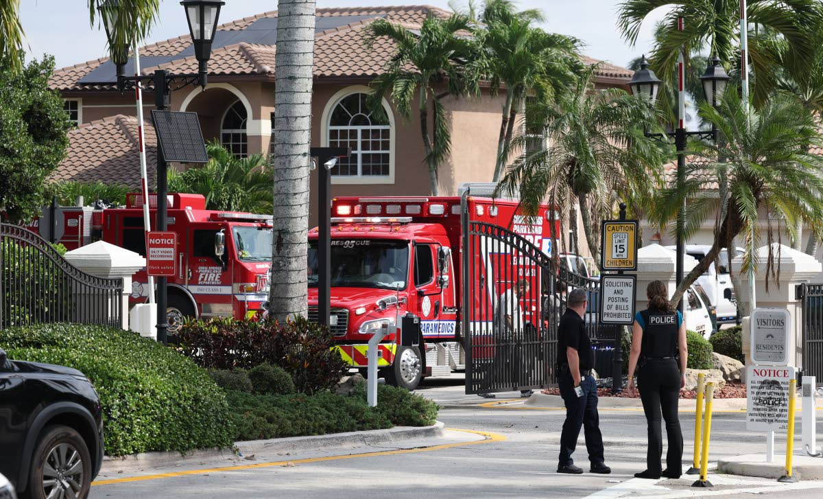 Emergency personnel from Coral Springs and Coconut Creek on scene where a plane crashed in the Windsor Bay community in Coral Springs on Monday, November 10, 2025. (Carline Jean/South Florida Sun-Sentinel via AP)
