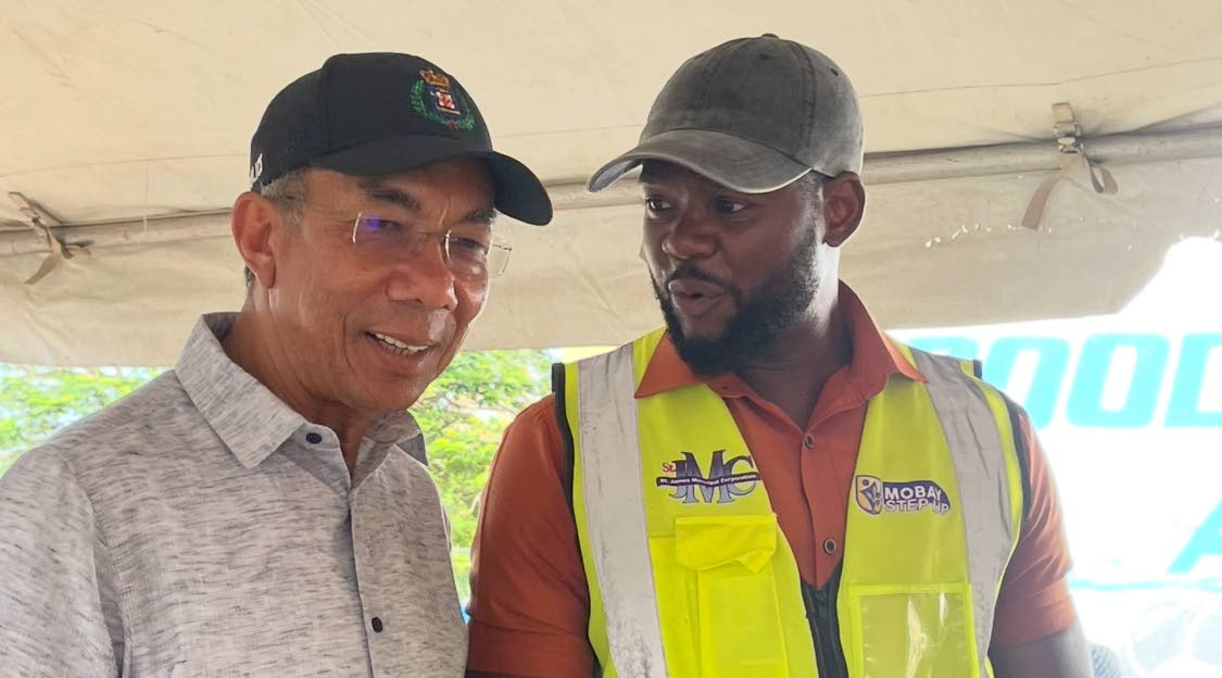 National Decurity Minister, Dr Horace Chang (left) in discussion with Montego Bay Mayor Richard Vernon