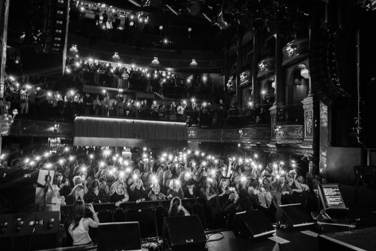 The audience remains fully engaged, moving in rhythm with the music and the message and capturing every moment.