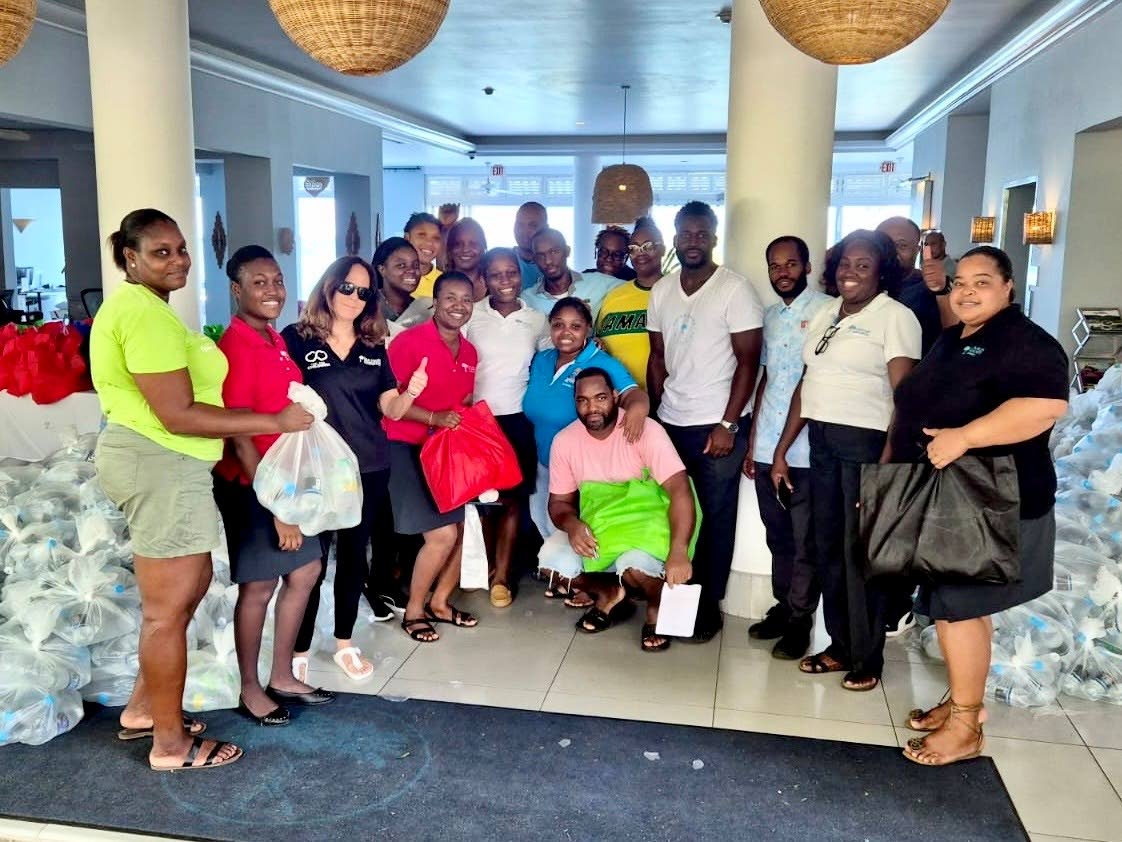Alexandra Ghisays, Issa Trust Foundation board member, along with the team from Couples Tower Isle, preparing to distribute care packages to the staff of the hotel last Friday.