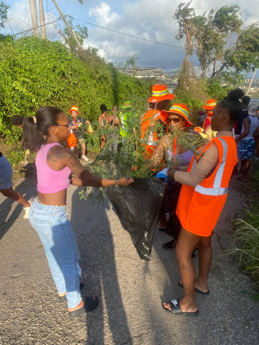 Hah-R-Mony Entertainment Limited workers clear debris from Montego Bay streets after Hurricane Melissa.