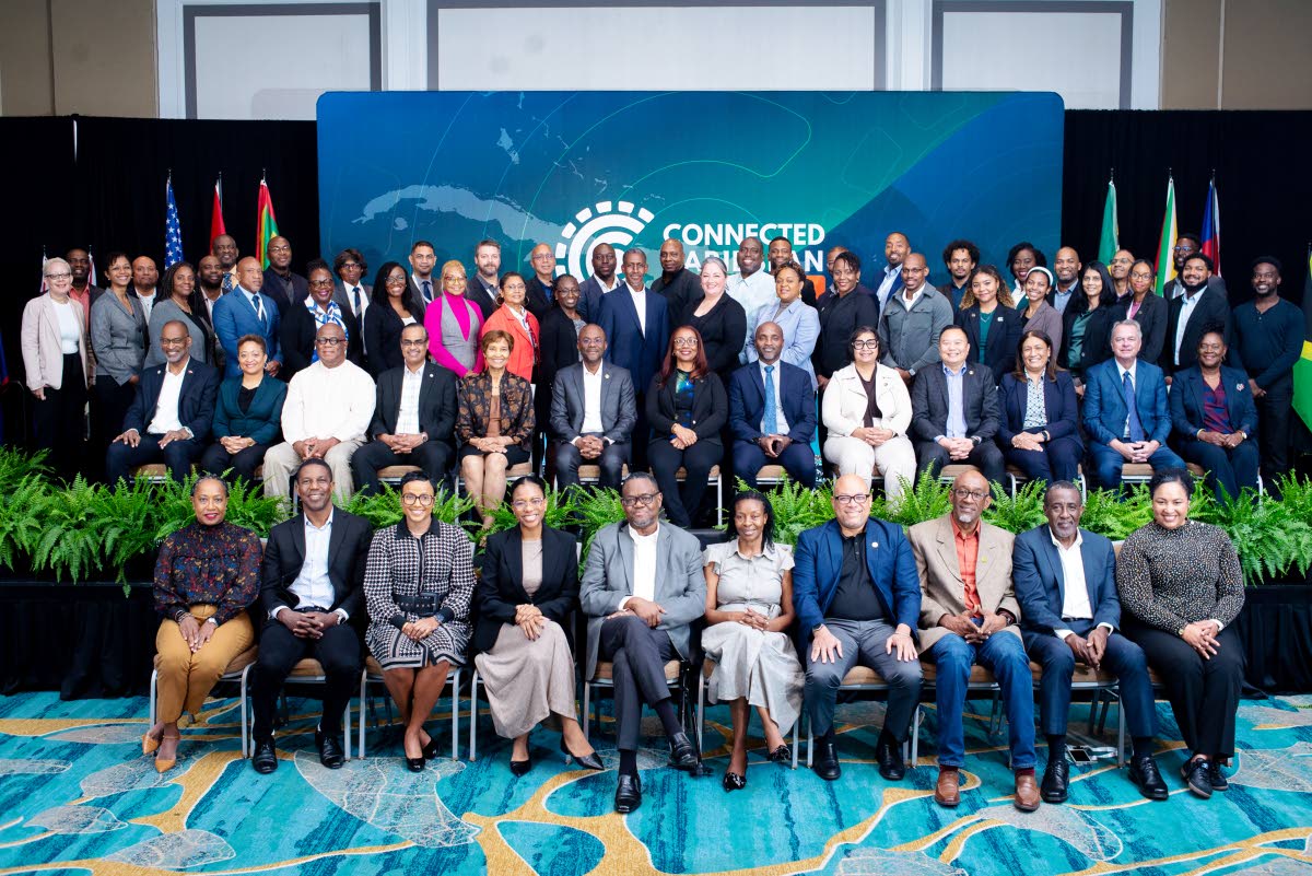 A cross-section of speakers and attendees pose for a photo at the Connected Caribbean Summit in Miami, Florida in December 2024.