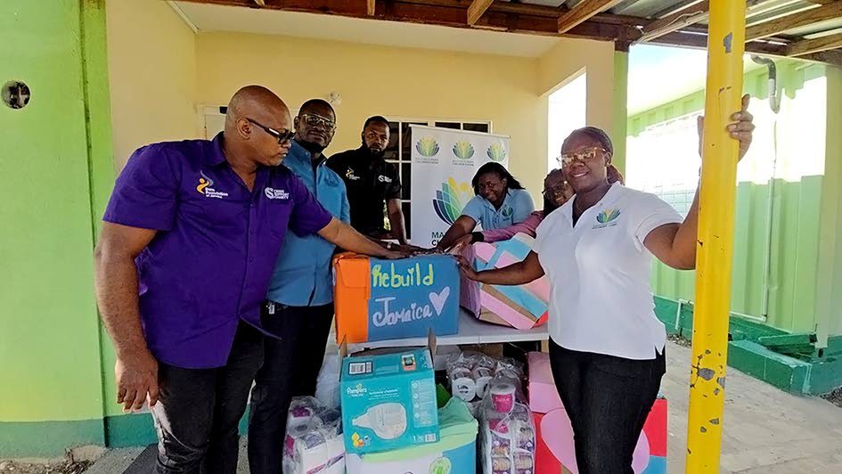 From left Stephen Josephs and Luke Josephs, co-founders of Crisis Support Charity; Wilfred Josephs, director, and Renae Tuckett Palmer (right), manager of the Maxfield Park Children’s Home, at the handing over of care packages prepared by the children an