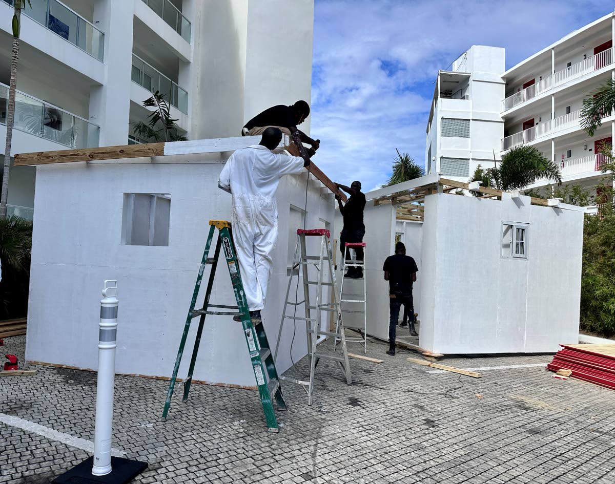 Construction workers  working on a few of the 60 homes.