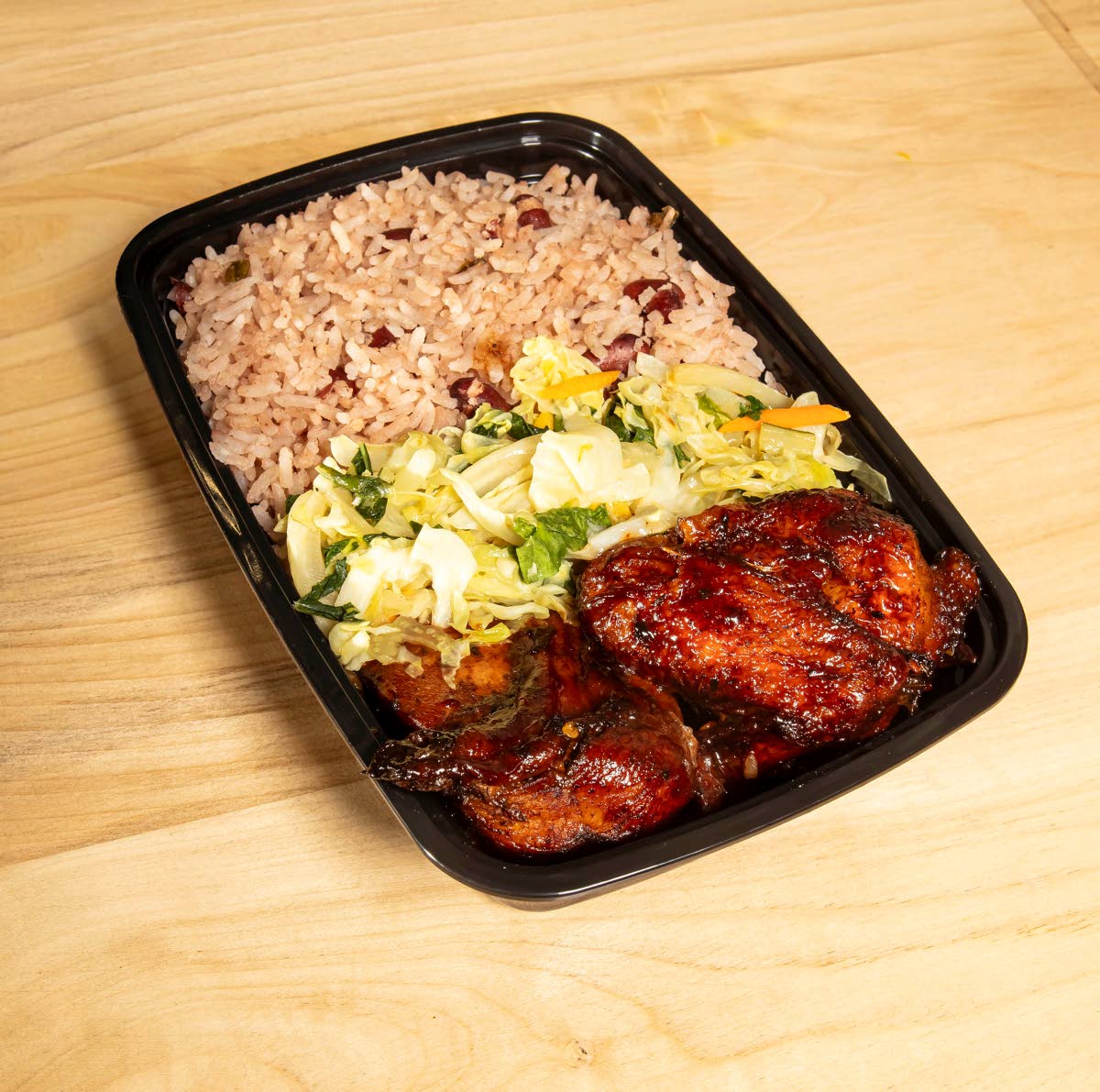Father Bull serves up favourites – baked chicken with rice and peas.