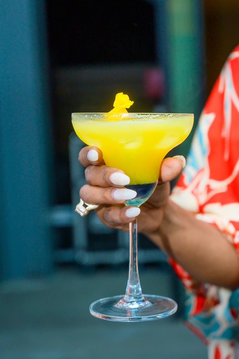 The Santorini sunset dazzled with its golden island blend of dark rum, Malibu, and passion fruit, served icy cold for a tropical sip as vibrant as its name.