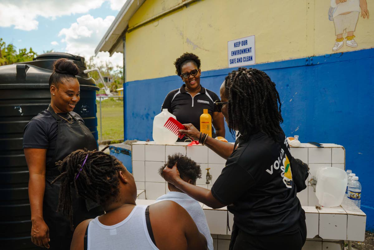 United4GoodJA volunteers provide grooming services to a young shelter resident in Westmoreland.
