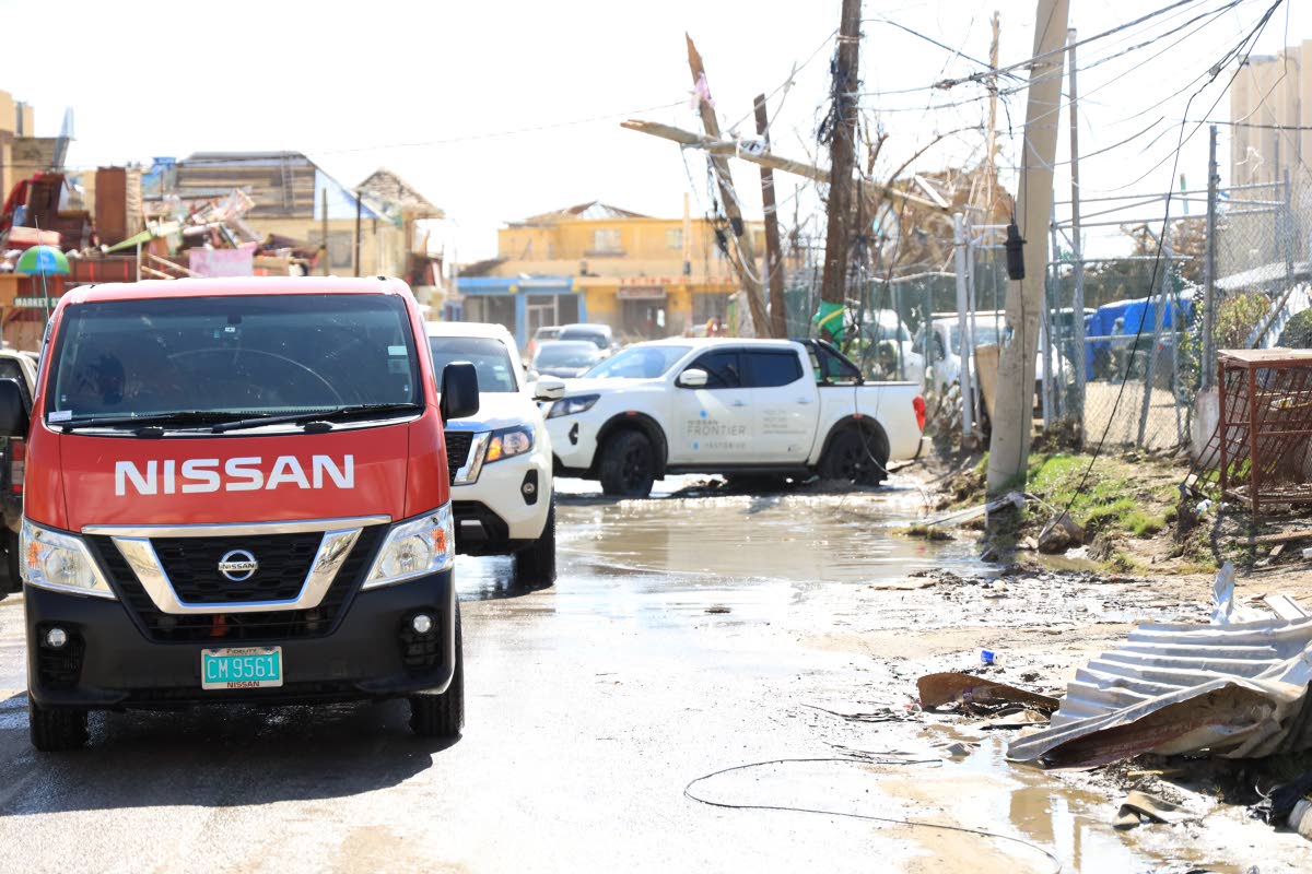 Fidelity Motors team, distributors of Nissan, navigate heavily affected terrain in Black River, St Elizabeth. 