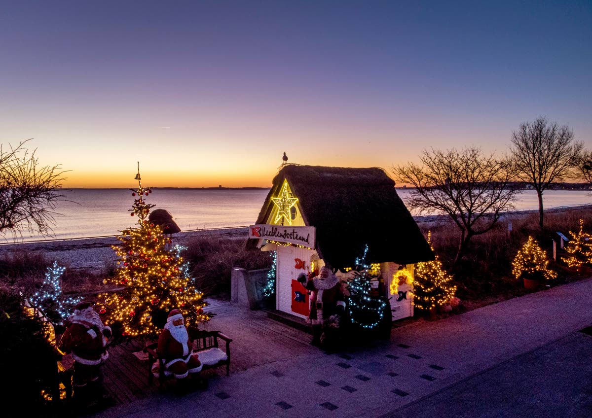 Christmas trees and Santa Clauses decorate the entrance to the beach in Haffkrug, northern Germany, in December 2021.