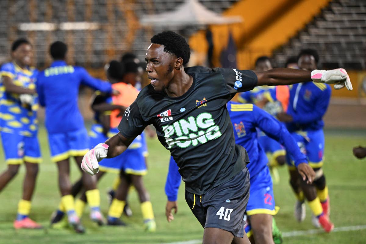 St Elizabeth Technical High School goalkeeper Jahnoi Steadman celebrates saving the penalty that gave his team an 8-7 sudden death penalty shootout win over Glenmuir High School in the ISSA daCosta Cup final at the National Stadium last night.