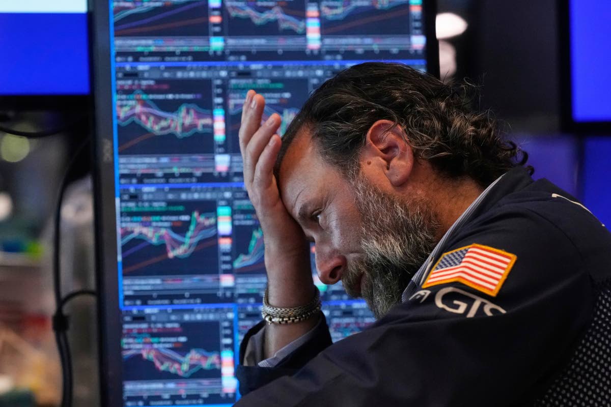 AP
Fluctuating markets has expert Michael Pistillo deep in thought on the floor of the New York Stock Exchange on Tuesday, July 8. 