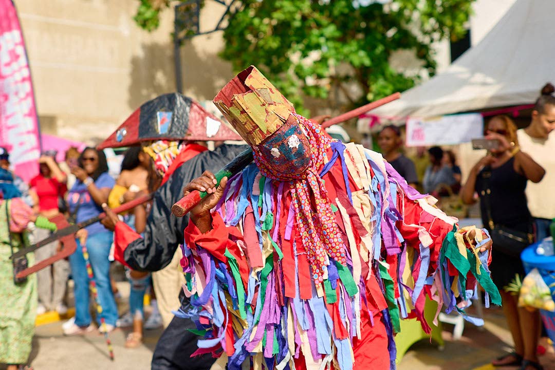 Pitchy Patchy performs adorned in colourful strips of fabric during the Sunday, December 21, Artwalk Festival Gran’ Market in the downtown Kingston art district. 