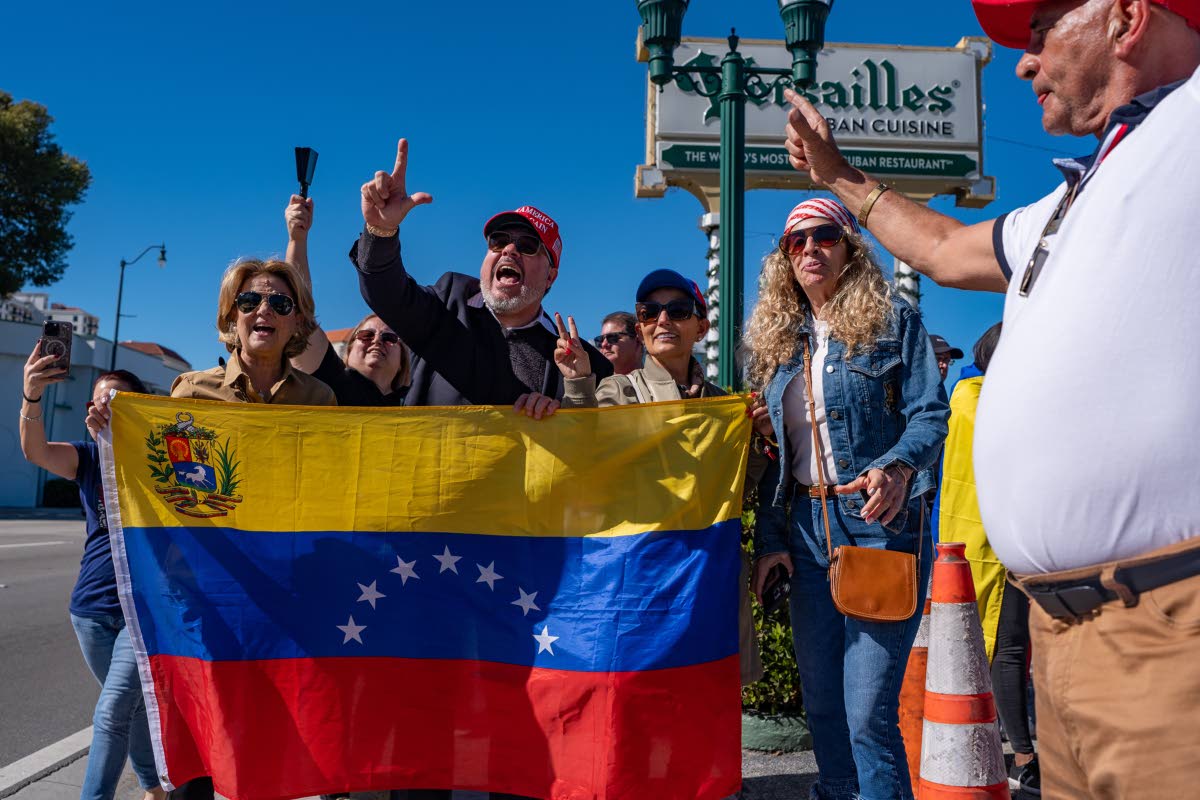 People celebrate outside Versailles Cuban Cuisine in Miami, Florida, on Saturday after US President Donald Trump announced Venezuelan President Nicolás Maduro had been captured and flown out of the country.