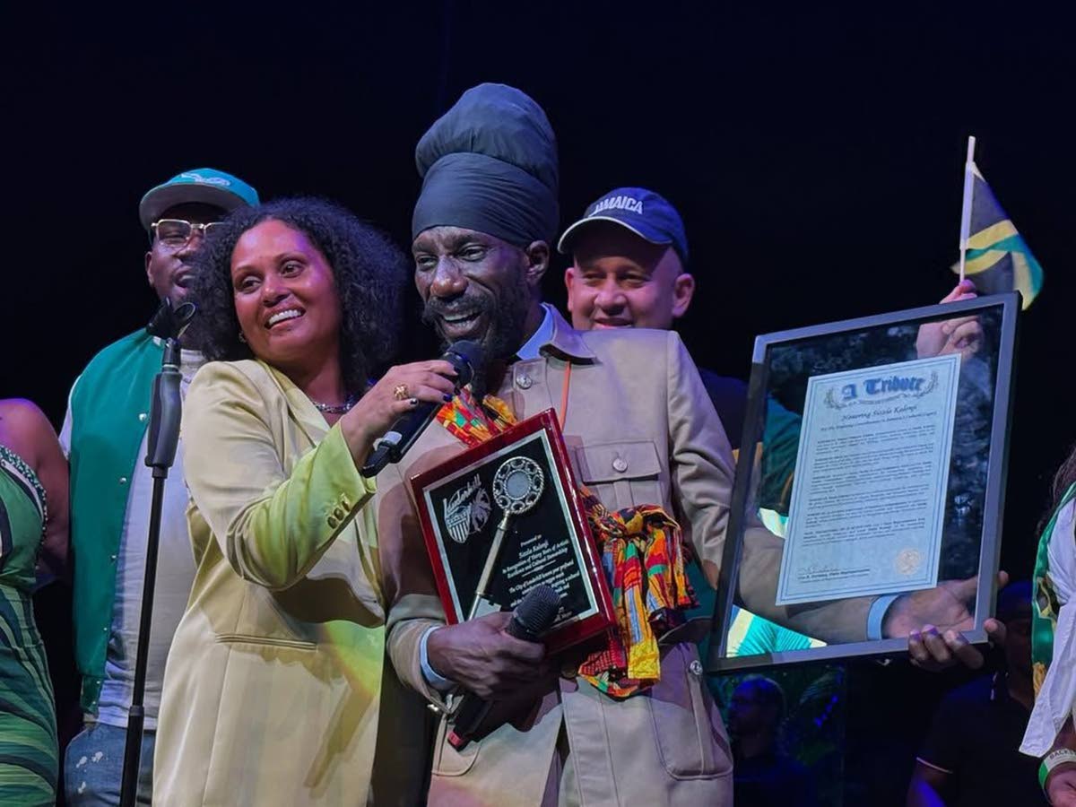 Sizzla accepts the Key to the City of Lauderhill from Mayor Denise D. Grant at a ceremony at the Lauderhill Performing Arts Center in August 2025.