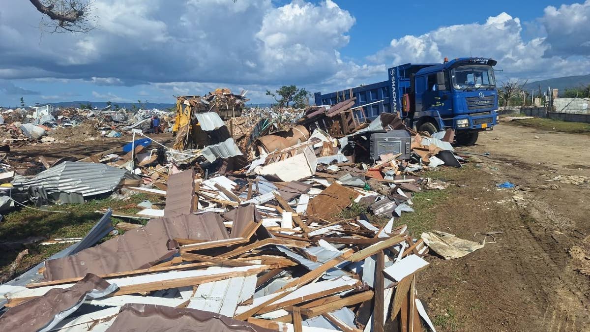 Crews of Southern Parks and Market clearing debris from Independence Park in Black River, St Elizabeth.  