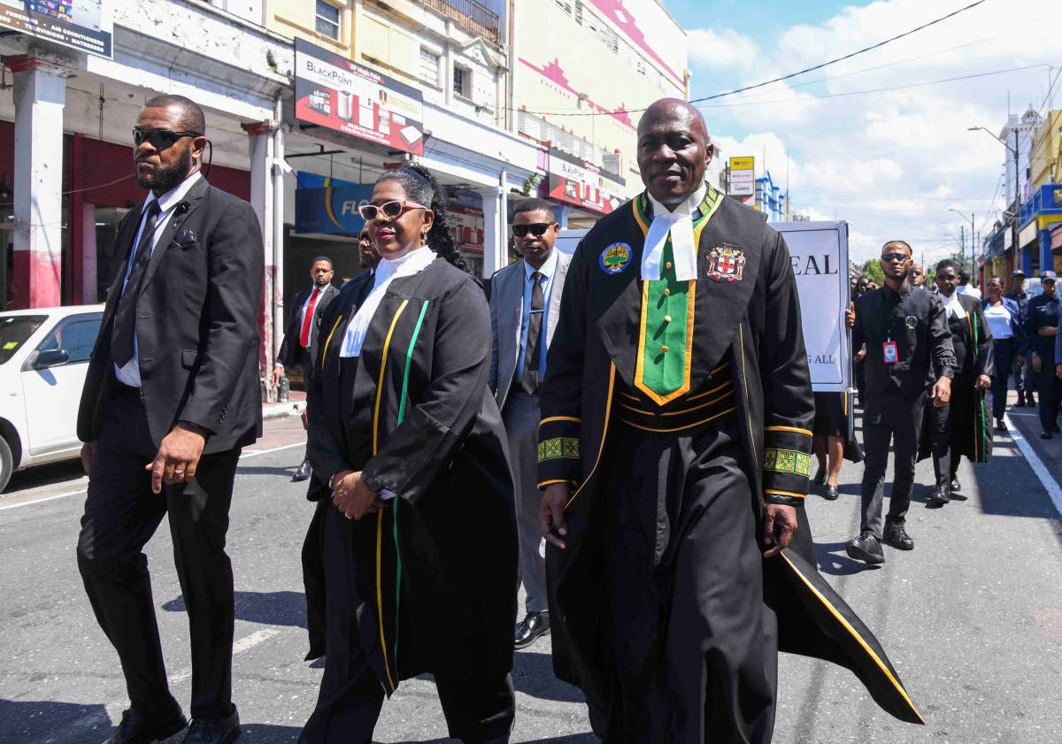 Members of the judiciary led by Chief Justice Bryan Sykes (right) and Marva McDonald Bishop, president of The Court of Appeal (second left),  marching along King Street in downtown Kingston in celebration of International Judiciary Day at the inaugural Jud