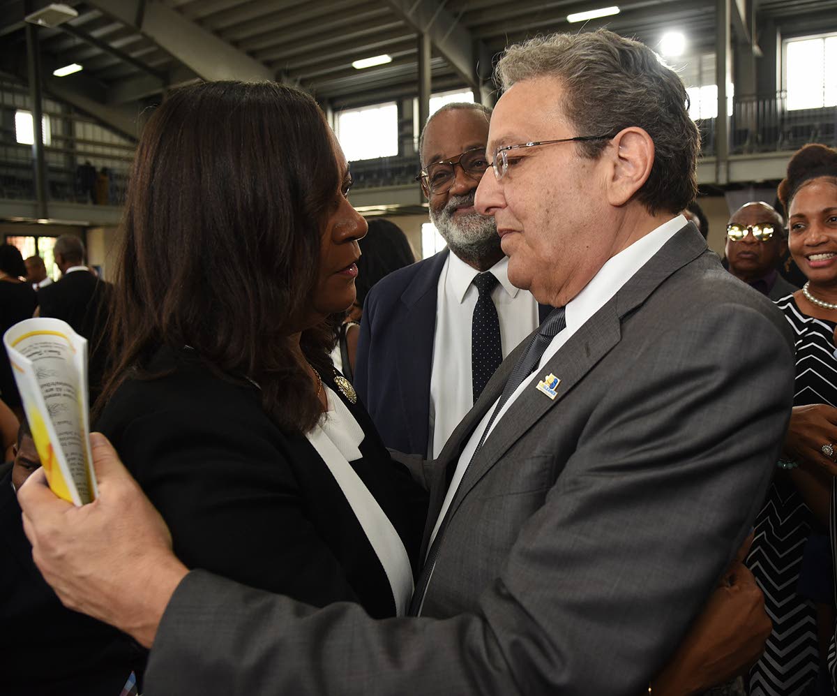 Joseph M. Matalon, executive chairman of the RJRGLEANER Communications Group, expresses his condolences to Karen Smith, wife of the late Anthony Smith, former CEO of the group, during a thanksgiving service for his life which was held inside the Karl Hendr