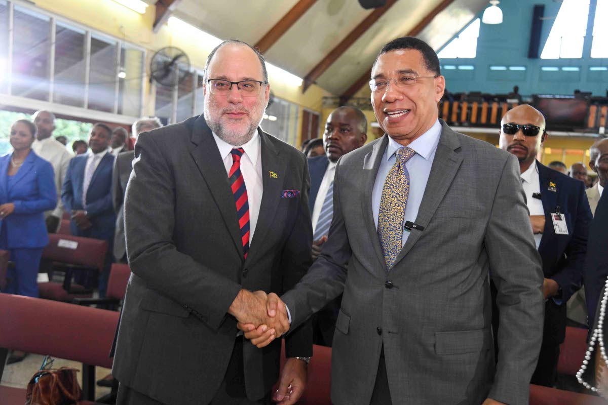 Prime Minister Dr Andrew Holness (right) and Opposition Leader Mark Golding share a moment at the 46th Annual National Leadership Prayer Breakfast held at Boulevard Baptist Church in St Andrew on Thursday.