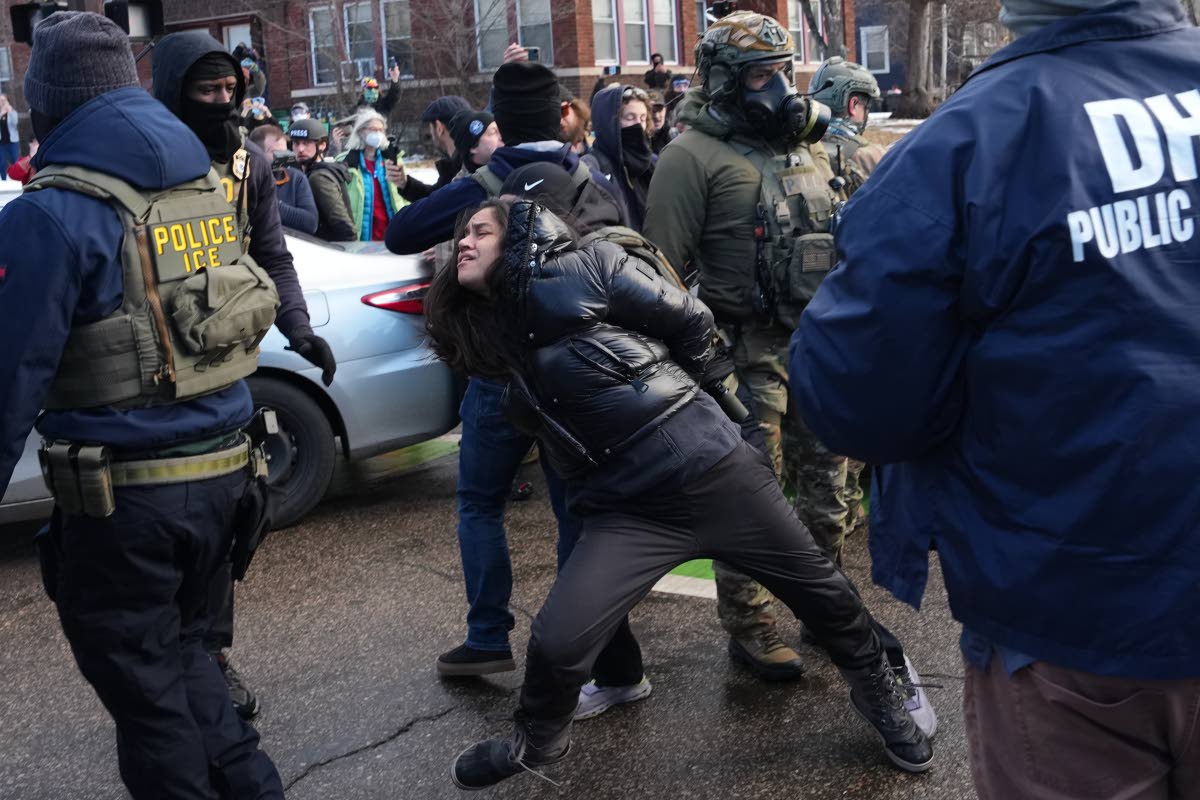 Aliya Rahman is detained by federal agents near the scene where Renee Good was fatally shot by an ICE officer last week, Tuesday, January 13, 2026, in Minneapolis. 