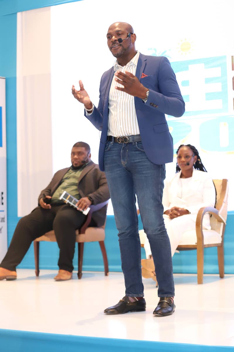 Sygnus Group CEO Berisford Grey addresses the JSE Capital Markets Conference on its final day, January 26, 2023. In the background are Simon Johnson and Simone Hudson, both of Stratus Alternative Funds SCC.