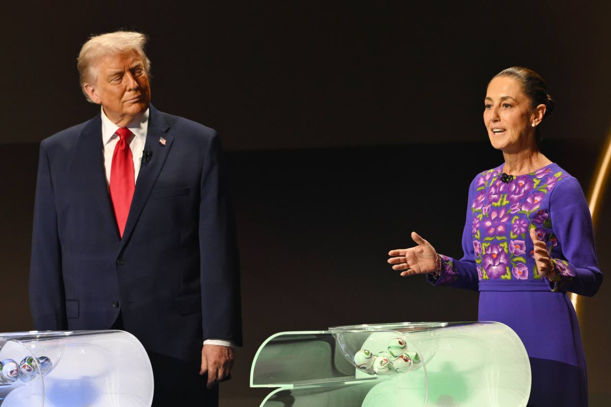 US President Donald Trump looks on as Mexican President Claudia Sheinbaum speaks on stage at the draw for the 2026 soccer World Cup at the Kennedy Centre in Washington, December 5, 2025. 