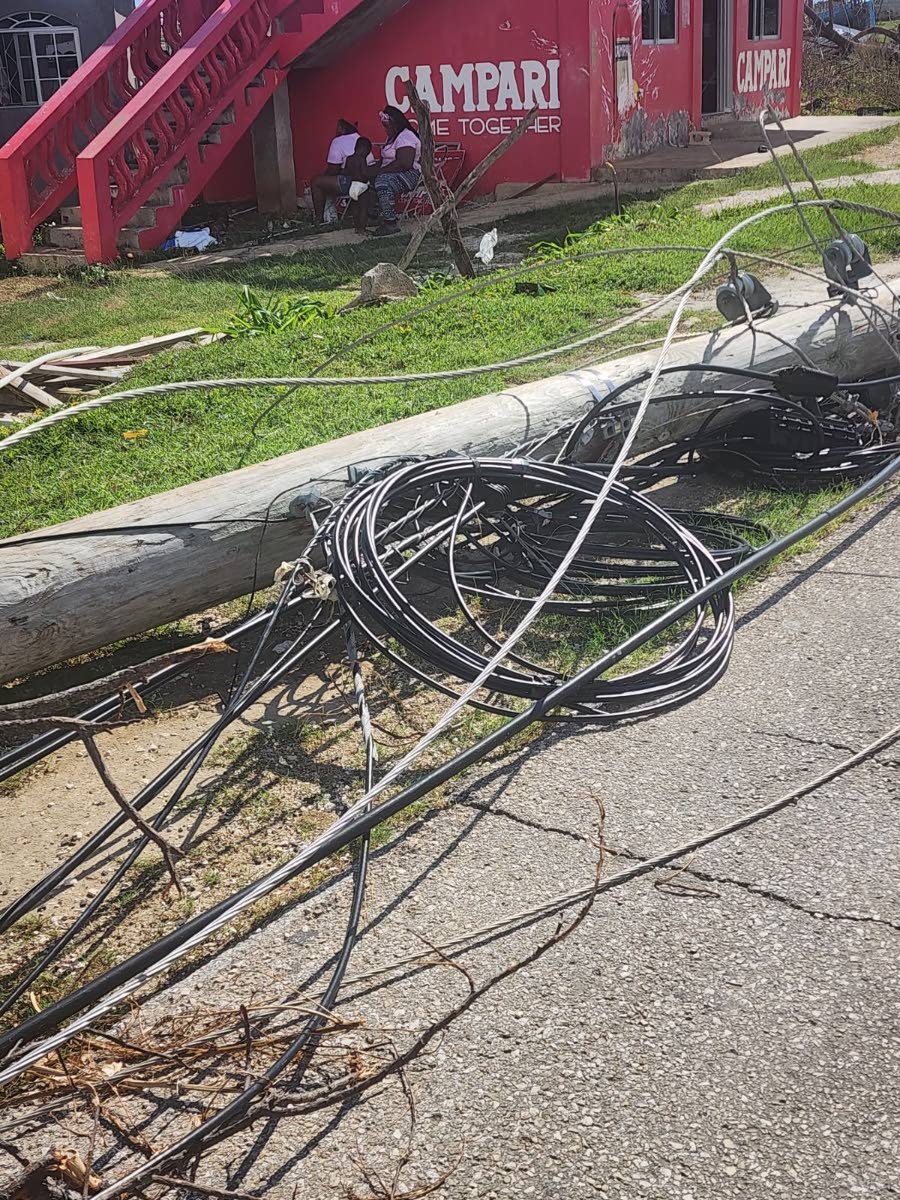 A downed utility pole showing mainly wires belonging to Hometime Cable after the passage of Hurricane Melissa.