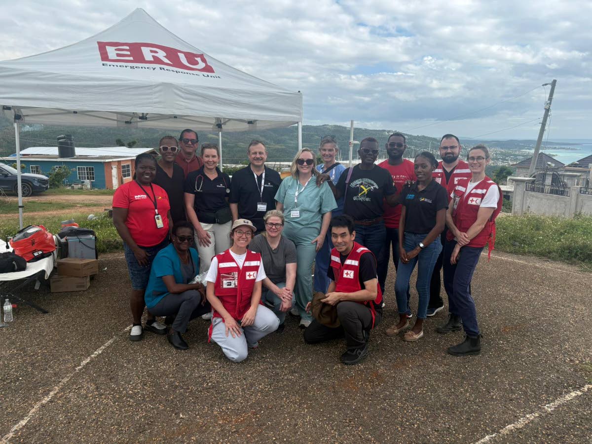 Volunteers from Team Broken Earth share a photo with health workers from the Red Cross and Westmoreland Public Health Services.