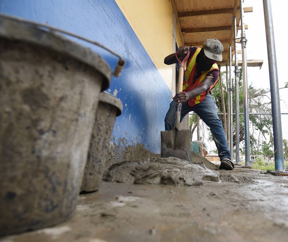 A construction workers mixes cement on February 5 to repair a section of the Lacovia Primary School in St Elizabeth that was damaged during the passage of Hurricane Melissa last October.