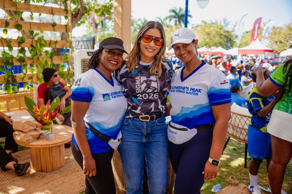 Marking 28 years of keeping participants refreshed at Sigma, Catherine’s Peak Brand Manager, Rochell Samuels-Black (left), and Allawney Bromley (right), senior brand manager for beverages, GraceKennedy Ltd.,  join Nicole Campbell Robinson, vice president