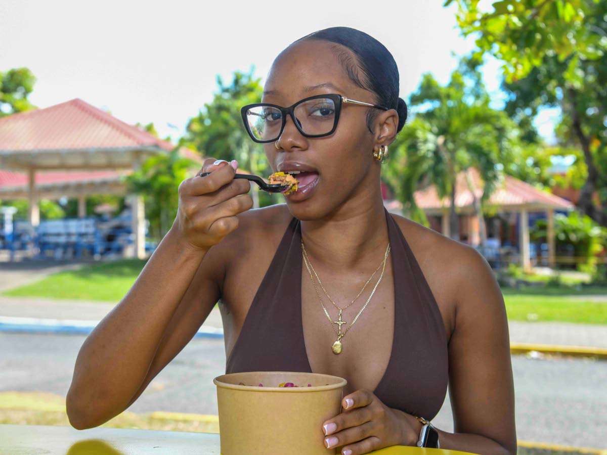 Third-year accounting student, Sade Simone, takes a bite of this festive yardie jerk bowl.