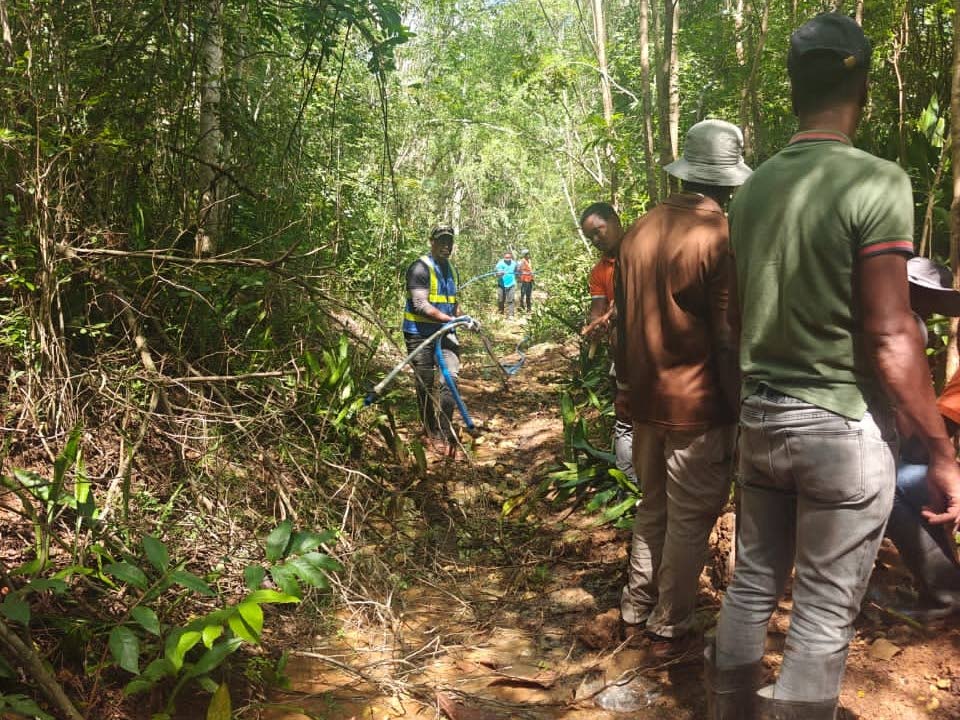 The National Water Commission personnel on an operation to remove illegal connections in Clarendon.