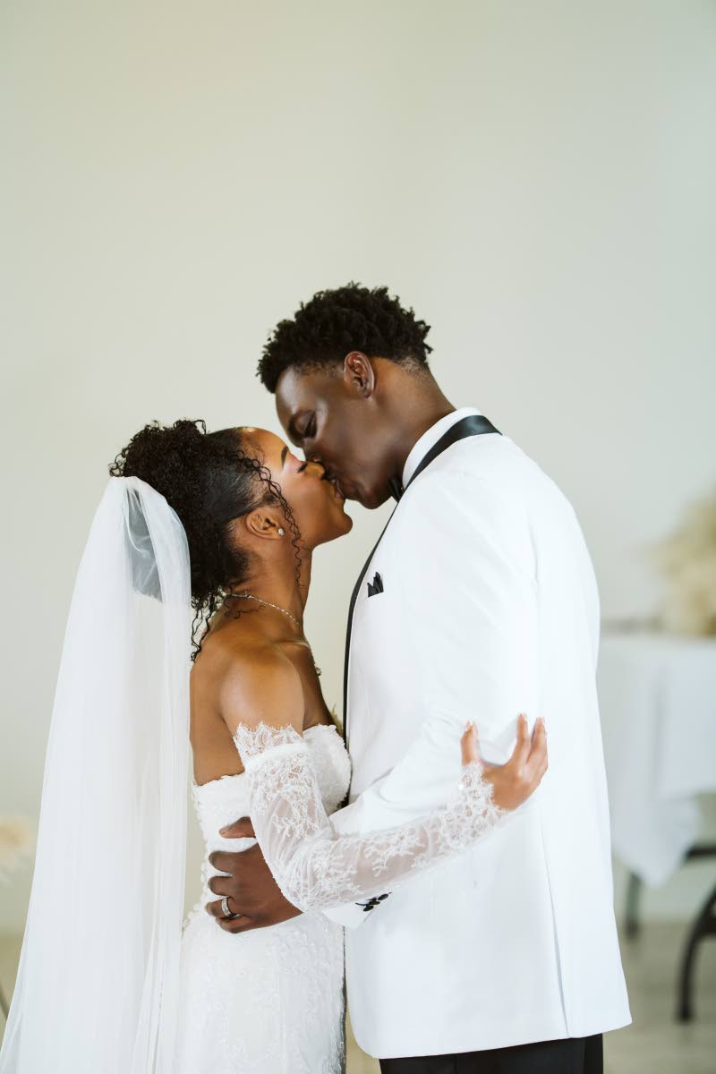 Rohanna and Dalkeith Thomas share a kiss as husband and wife.