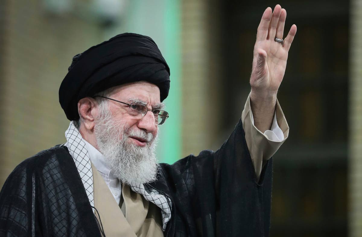 In this photo released by the official website of the office of the Iranian supreme leader, Supreme Leader Ayatollah Ali Khamenei waves to the crowd during his meeting with a large group of laborers in Tehran, Iran, May 10, 2025. 