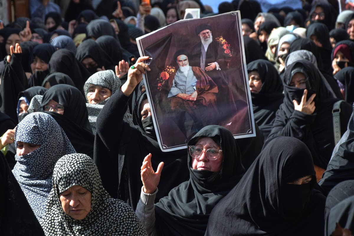 Shiite Muslims hold the portraits of Iranian leaders during a rally to condemn the killing of Iranian Supreme Leader Ayatollah Ali Khamenei, in Quetta, Pakistan on March 1, 2026. (AP Photo/Arshad Butt)