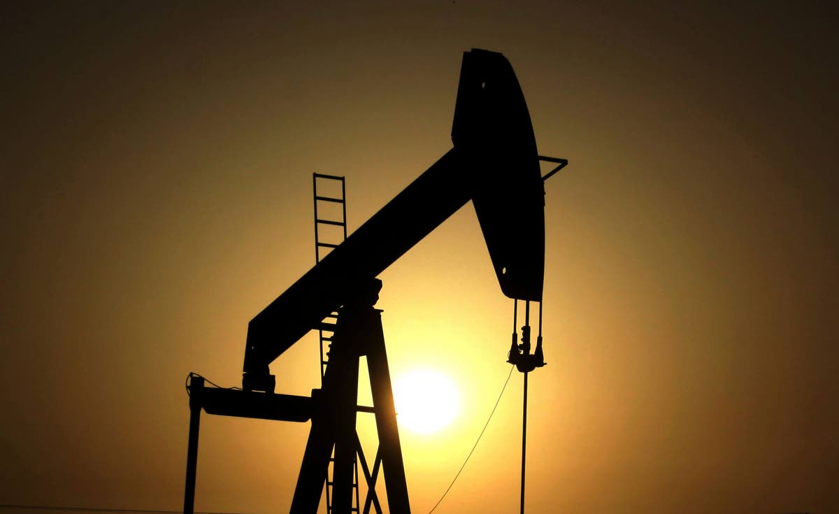 In this June 8, 2011 file photo, sun sets behind an oil pump in the desert oil fields of Sakhir, Bahrain. (AP Photo/Hasan Jamali, File)