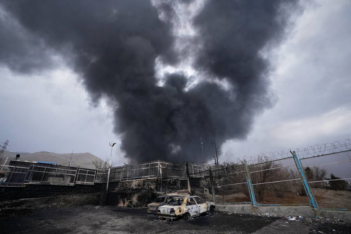 A thick plume of smoke rises from an oil storage facility hit by a US-Israeli strike in Tehran, Iran on March 8, 2026.