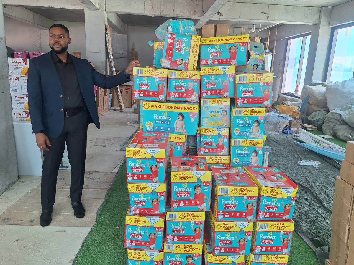 Mayor of Montego Bay Richard Vernon displays some of the supplies received by the St James Municipal Corporation from the Chinese business community in Guadeloupe.
